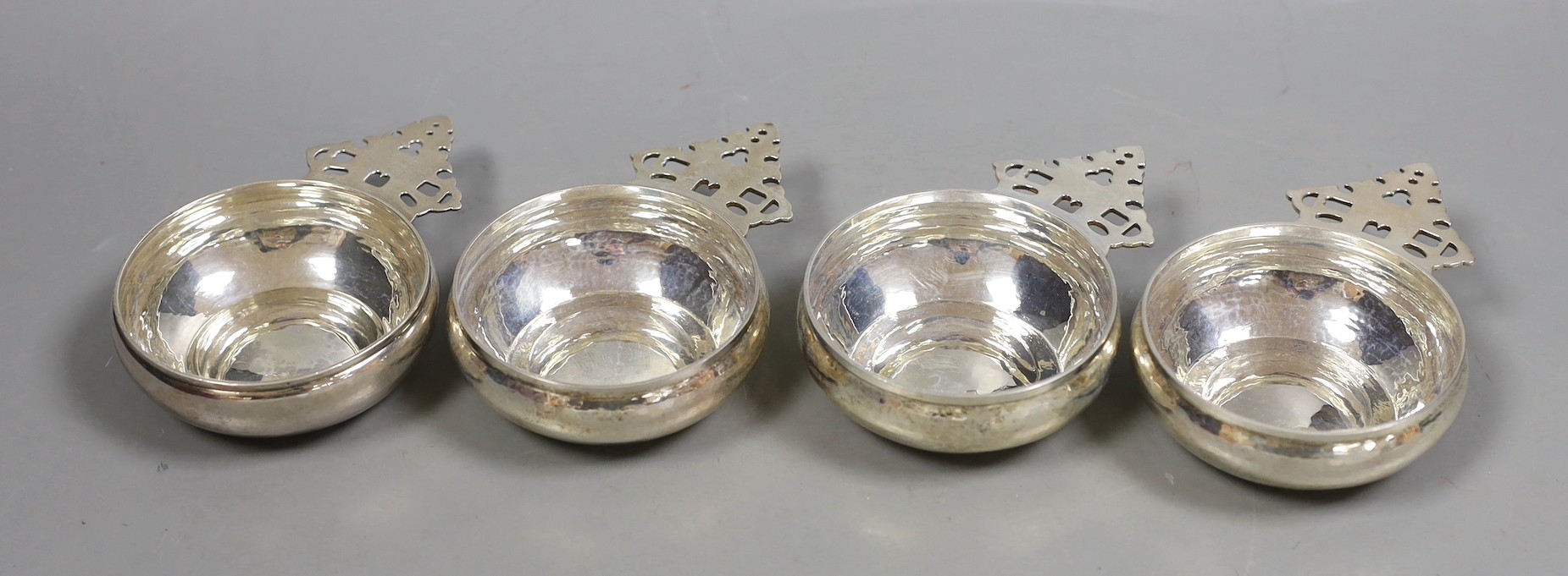 A matched set of four silver Tessier porringers, with pierced handles, London, 1946(1) and 1990(3), 11.6cm, 16.2oz.